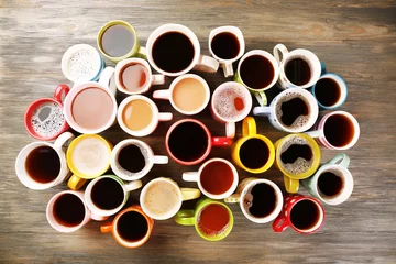Fotobehang Many cups of coffee on wooden table, top view © Africa Studio