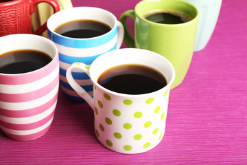 Many cups of coffee on pink background