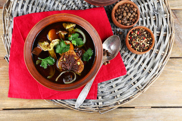 Mushroom soup on wicker mat and color napkin, top view