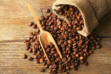 Coffee beans on wooden table, closeup