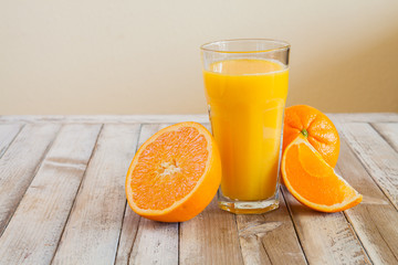 Orange fruit and glass of juice on white wooden background - 81531328