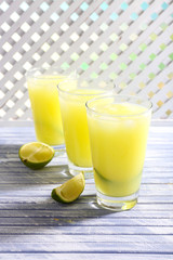 Glasses of cocktails on wooden lattice background