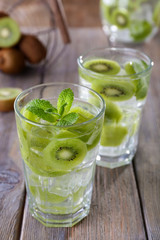 Glasses of cocktails on wooden table, closeup