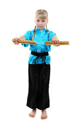 Little girl in kimono doing exercises with nunchaku isolated on white