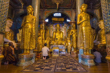 Myanmarese man and monk pay respect to Buddha Image