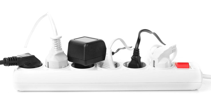 Many plugs plugged in extension cord isolated on white