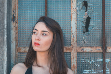 Beautiful brunette posing in an industrial context