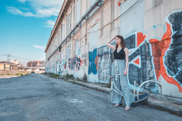 Beautiful brunette posing in an industrial context