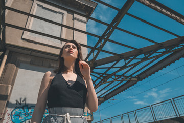 Beautiful brunette posing in an industrial context