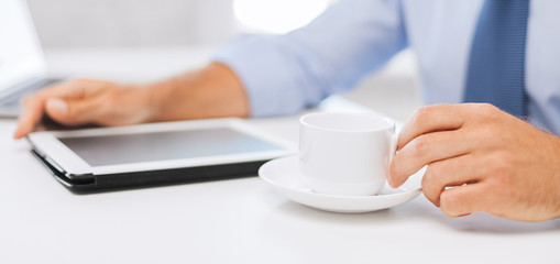 businessman with tablet pc and coffee in office