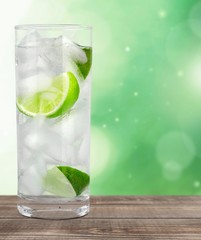 Vodka. Cocktail with ice and lime slice isolated on white