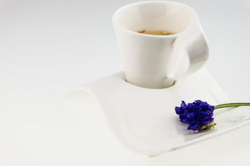Tea  time  with Statice flower isolated on white
