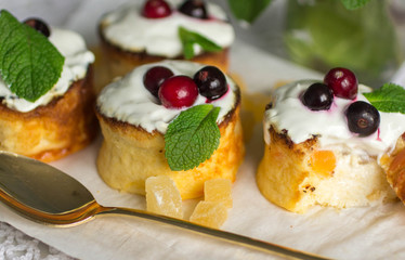 Curd pudding with candied fruit and fresh berries. Soft focus