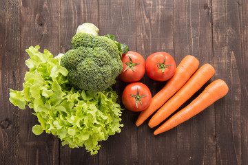 set of fresh vegetables on wood table.