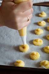 Piping Choux Paste for Cream Puffs onto Parchment-lined Pan