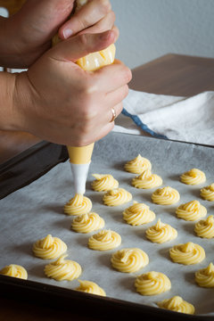 Piping Choux Paste for Cream Puffs onto Parchment-lined Pan