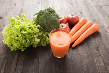 Carrot smoothie with fresh ingredients and vegetable.