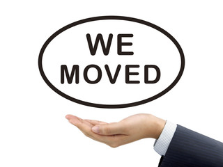 we moved words holding by businessman's hand