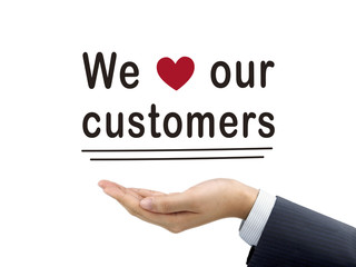 we love our customers words holding by businessman's hand