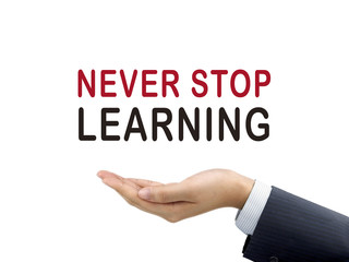 never stop learning words holding by businessman's hand
