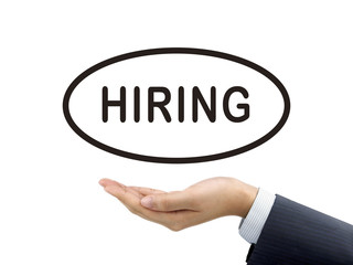 hiring word holding by businessman's hand