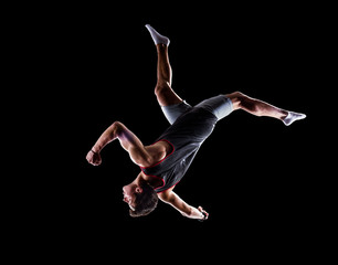 Isolated black young man is jumping on trampoline