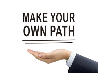 make your own path words holding by businessman's hand