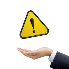 businessman's hand holding warning sign