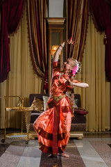 White woman is dancing in traditional indian dress