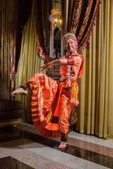 Fototapeta na wymiar White woman is dancing in traditional indian dress