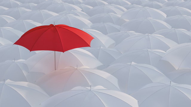 Red umbrella standing out from crowd mass concept