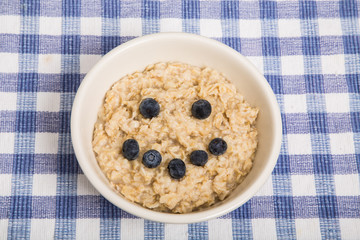 Oatmeal in Bowl with Blueberry Smiley Face