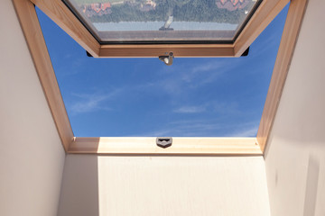 Opened roof window dormer with white wall