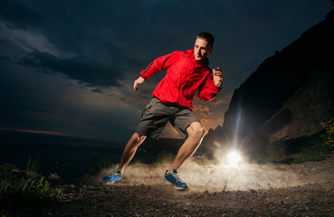 Fototapeta na wymiar Man running in the mountains at night.