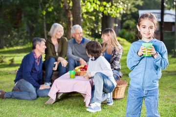 Girl Holding Glass Of Juice At Campsite