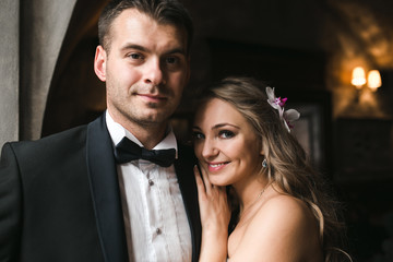 The bride and groom in a cozy house, photo taken with natural li