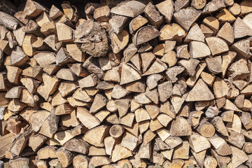 firewood stacked in a woodpile in the yard
