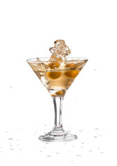 A martini glass on a white background; the water ripples