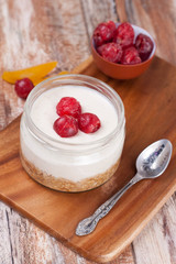 dessert with cookies, cherry and whipped cream in a glass