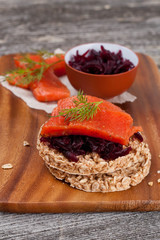 canape with grain crackers with beetroot and salmon