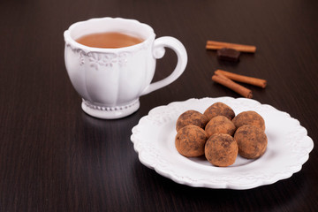 Chocolate truffles on a plate and tea
