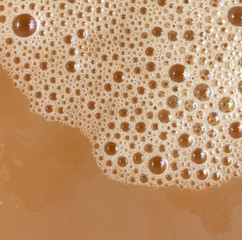foam on the surface of coffee with milk