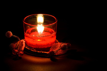 Decorative glass candle, on black background