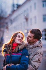 Fototapeta premium Portrait of young beautiful couple kissing in rain