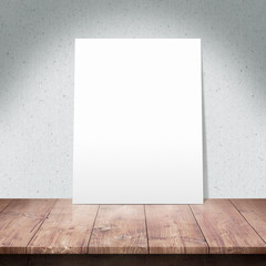 White poster on a wooden table with Fabric background
