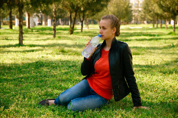 Beautiful woman with plastic bottle of water