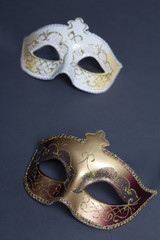 close up of two beautiful carnival masks on grey