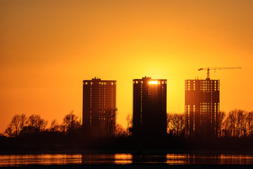 Construction site on river bank in the sunset