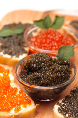 Black and red caviar in glass container