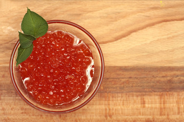 Black and red caviar in glass container